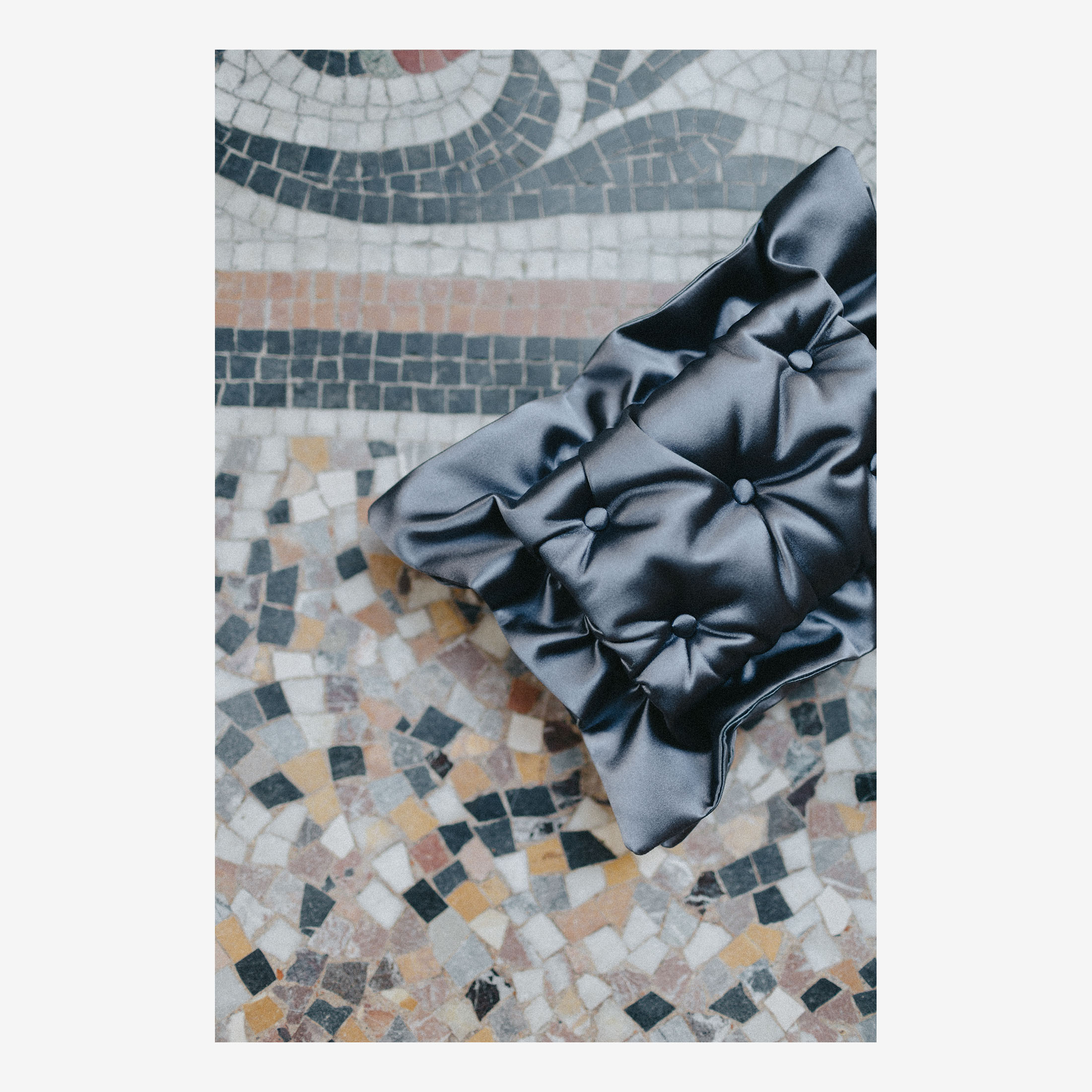 Laimushka dark grey quilted silk pillow clutch bag on the floor in Paris, Palais Royal.