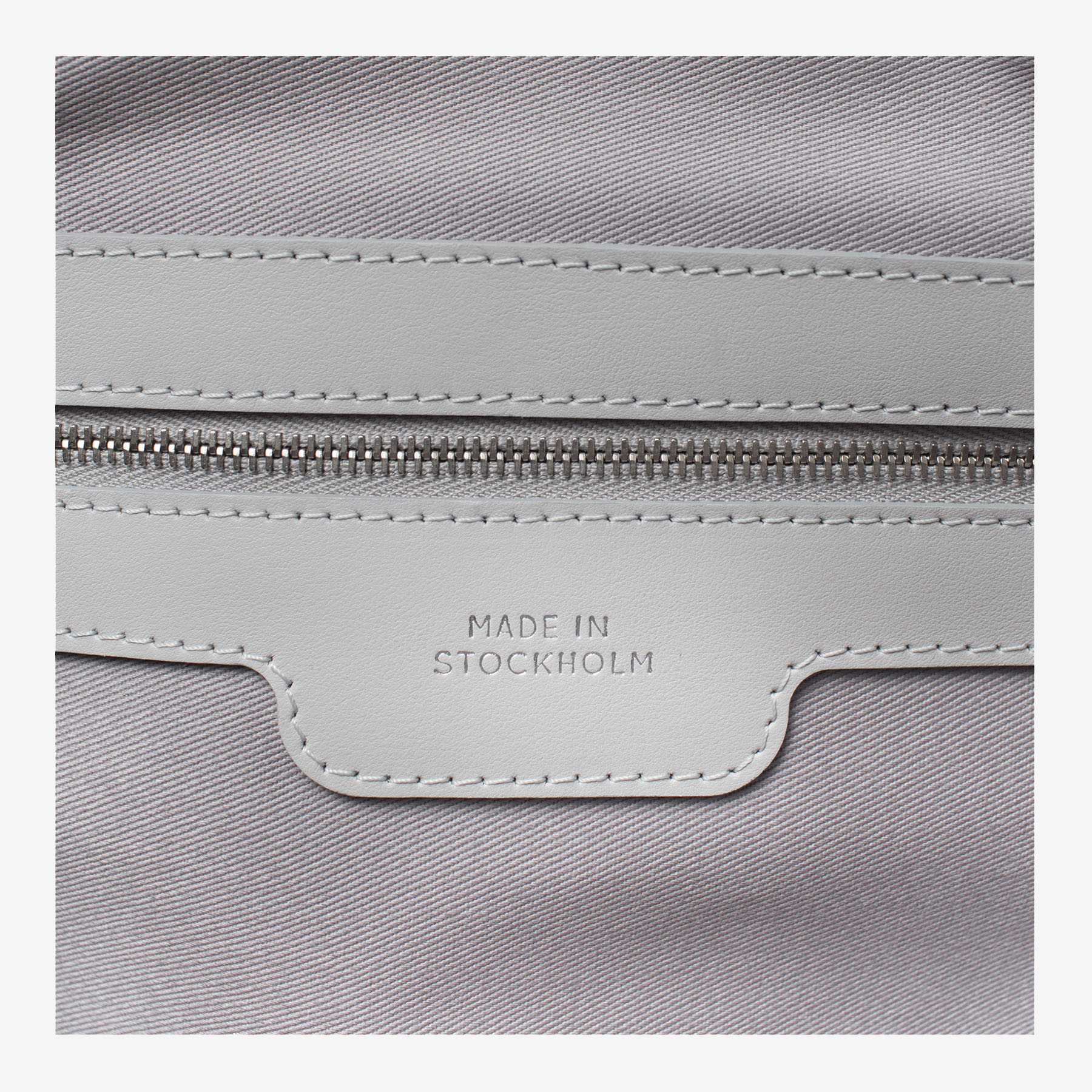 Laimushka leather bag’s interior zip pocket with tag Made in Stockholm